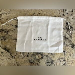 white drawstring dust bag by Coach.